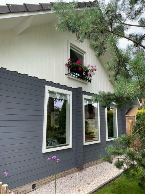 wooden forrest house painted in grey and white